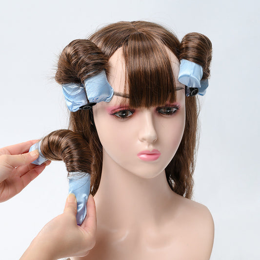 Glowglo lazy hair curler with blue fabric wraps shaping brown hair on mannequin head
