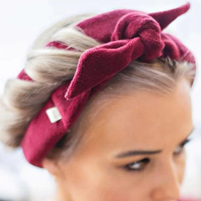 Glowglo velvet heatless hair curler in burgundy wrapped around blonde hair for soft curls